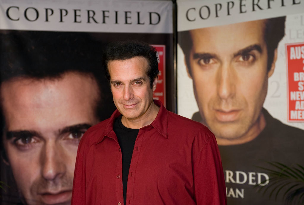 david copperfield in front of giant headshots of himself