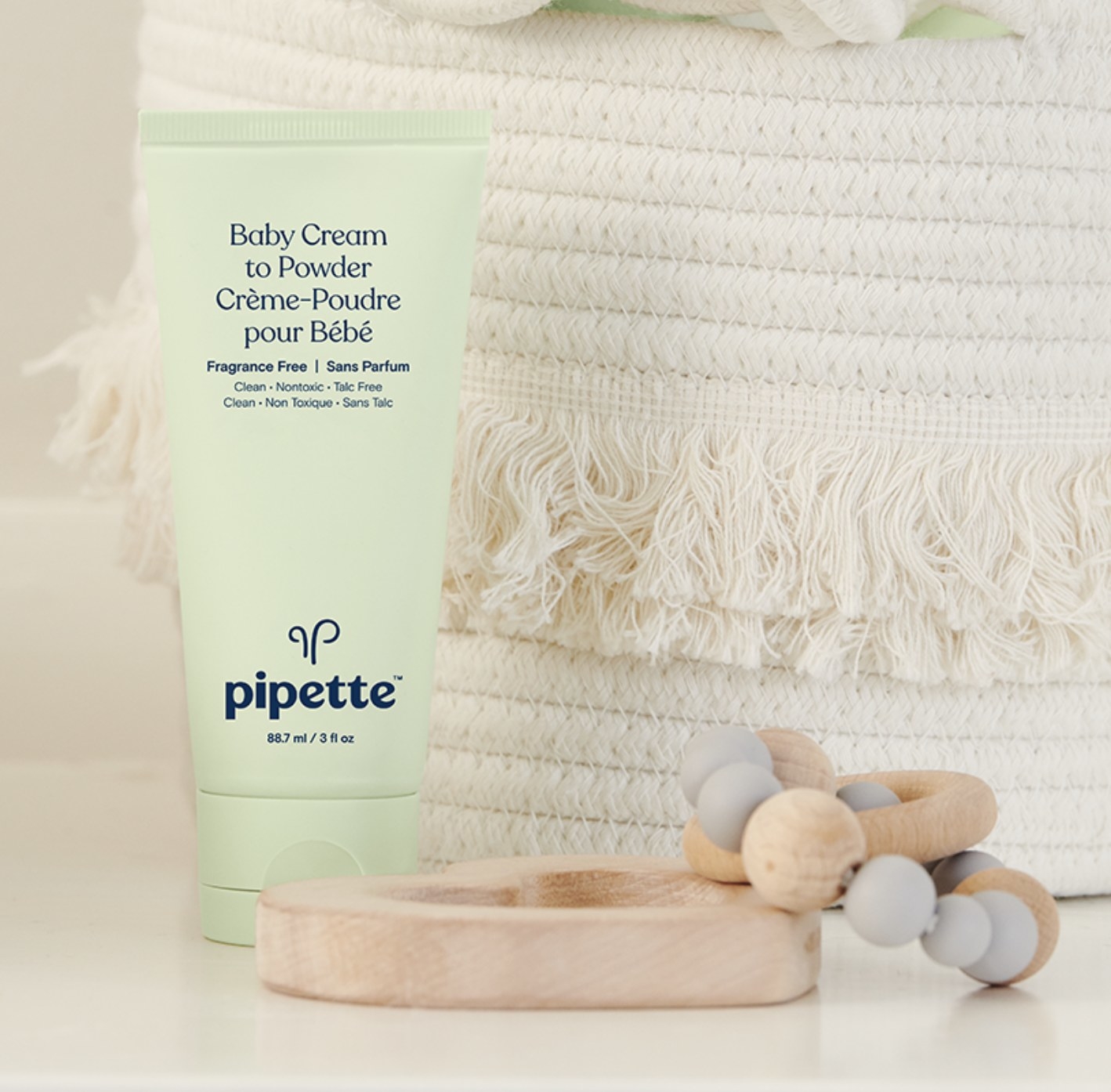 the cream to powder next to a baby toy