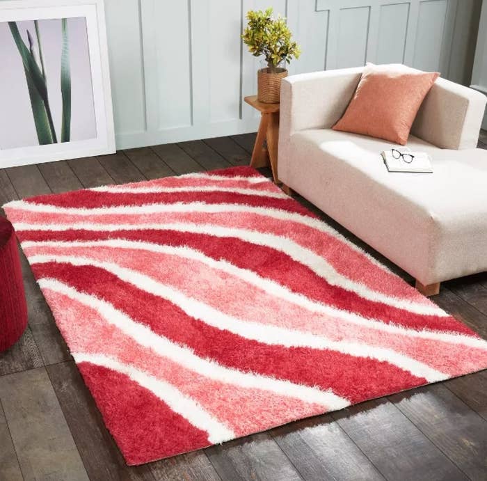 the area rug in pink red and white waves