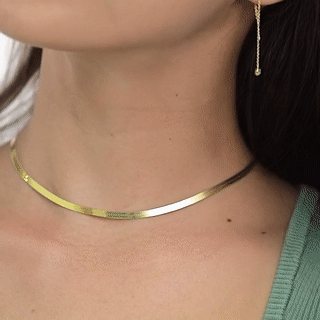 gif with a closeup of the necklace shining