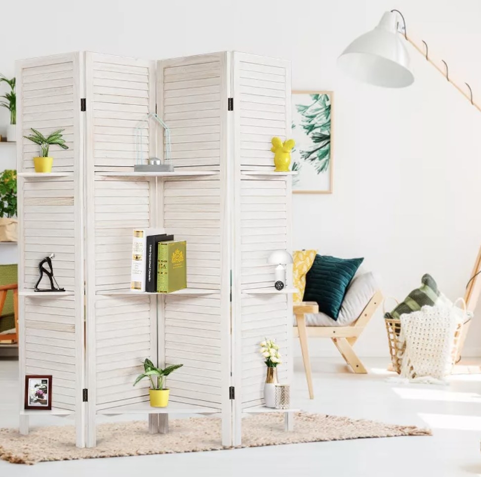 the room divider with plants and decor on the shelves
