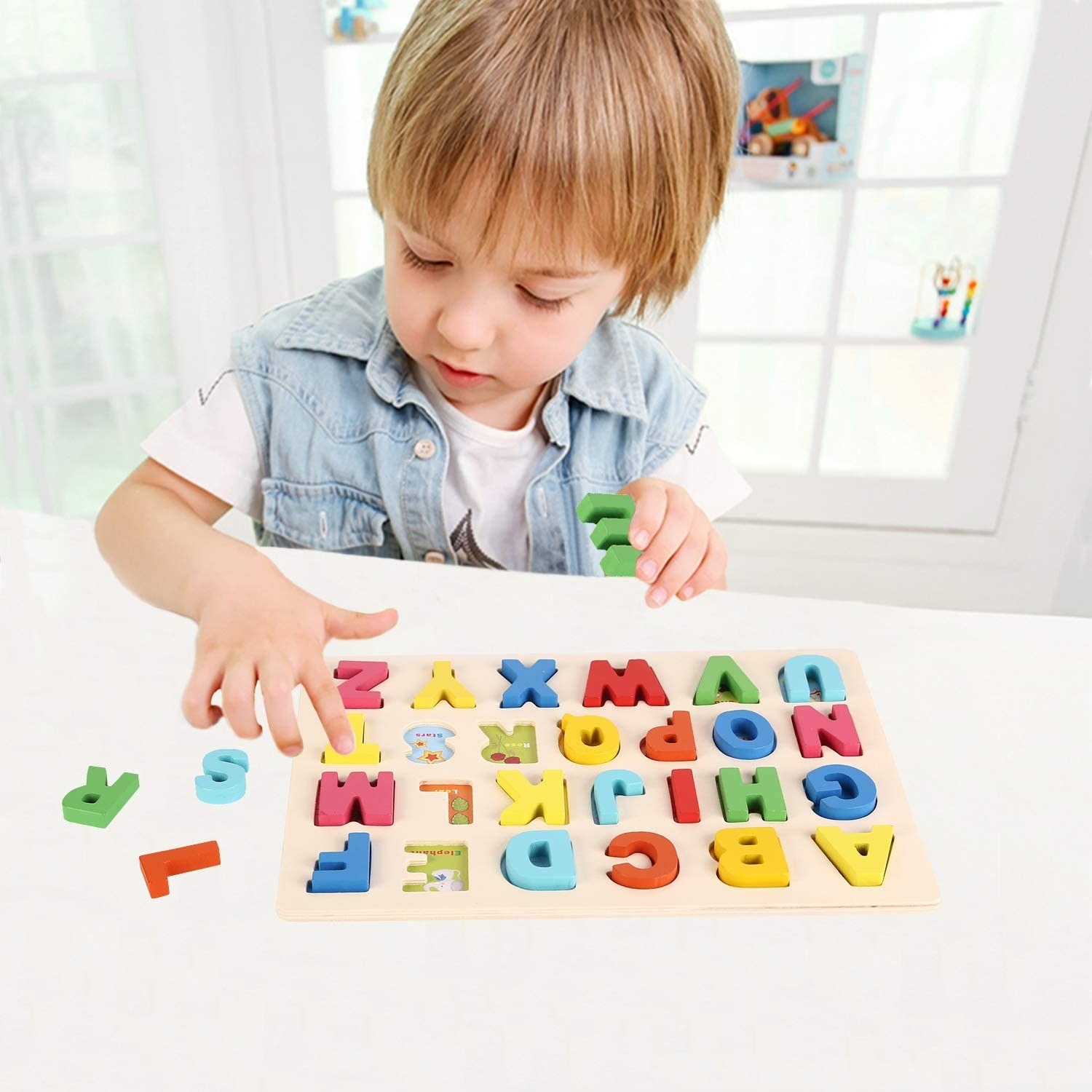 A child playing with an alphabet puzzle