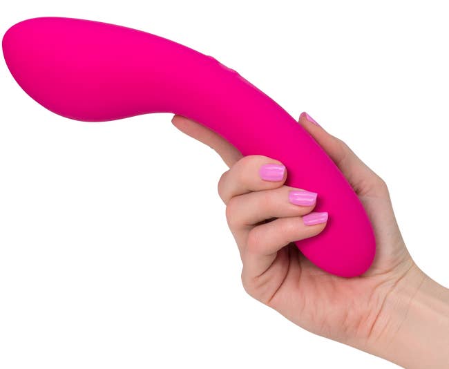 Model holding hot pink vibrator