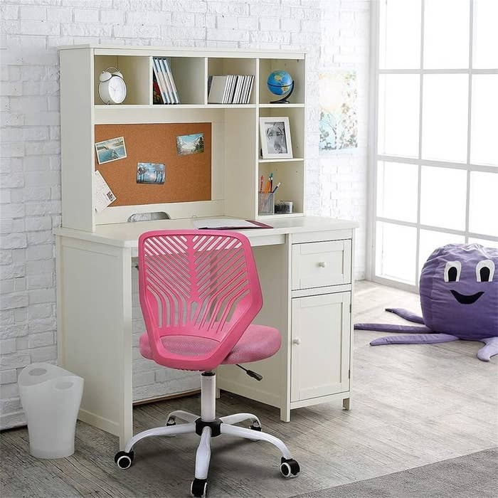 the pink chair at a decorated desk