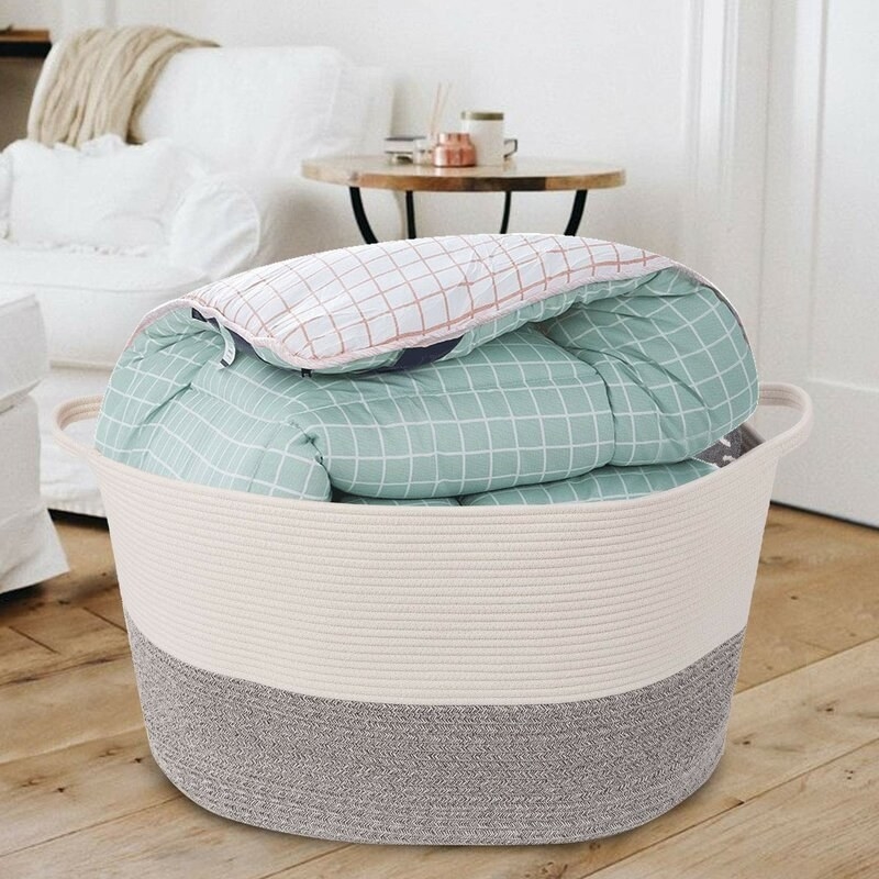 The fabric basket with blankets inside