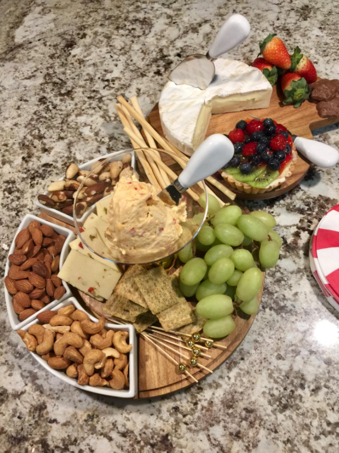 reviewer image of cheese board prepared with tons of snacks