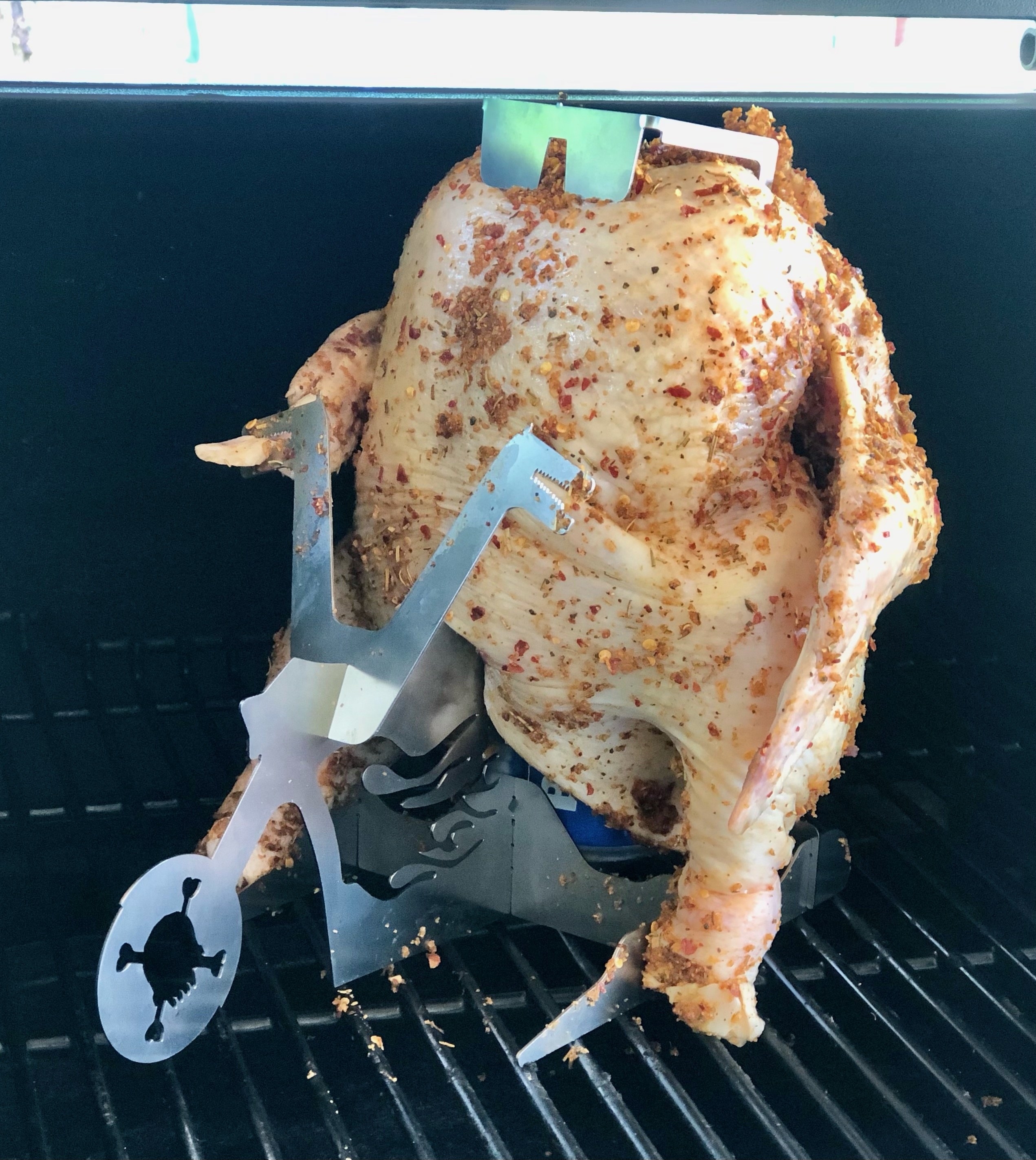 photo author took of chicken resting on the stand on top of a grill