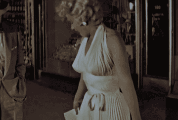 GIF of Marilyn&#x27;s dress being blown up, exposing her thighs