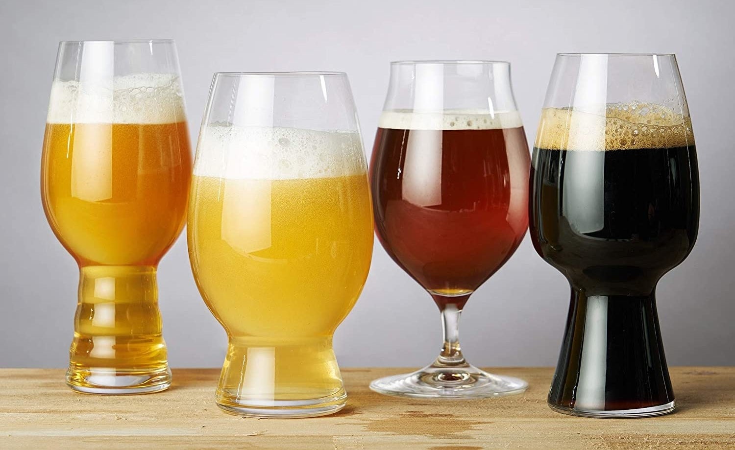 a set of four different beer glasses for different styles of ale