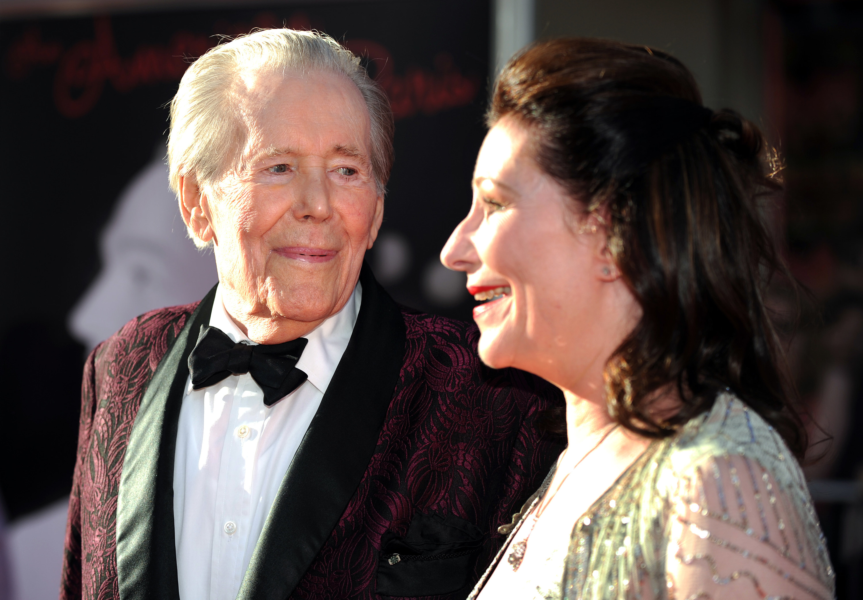 Peter wears a tuxedo and smiles at an event