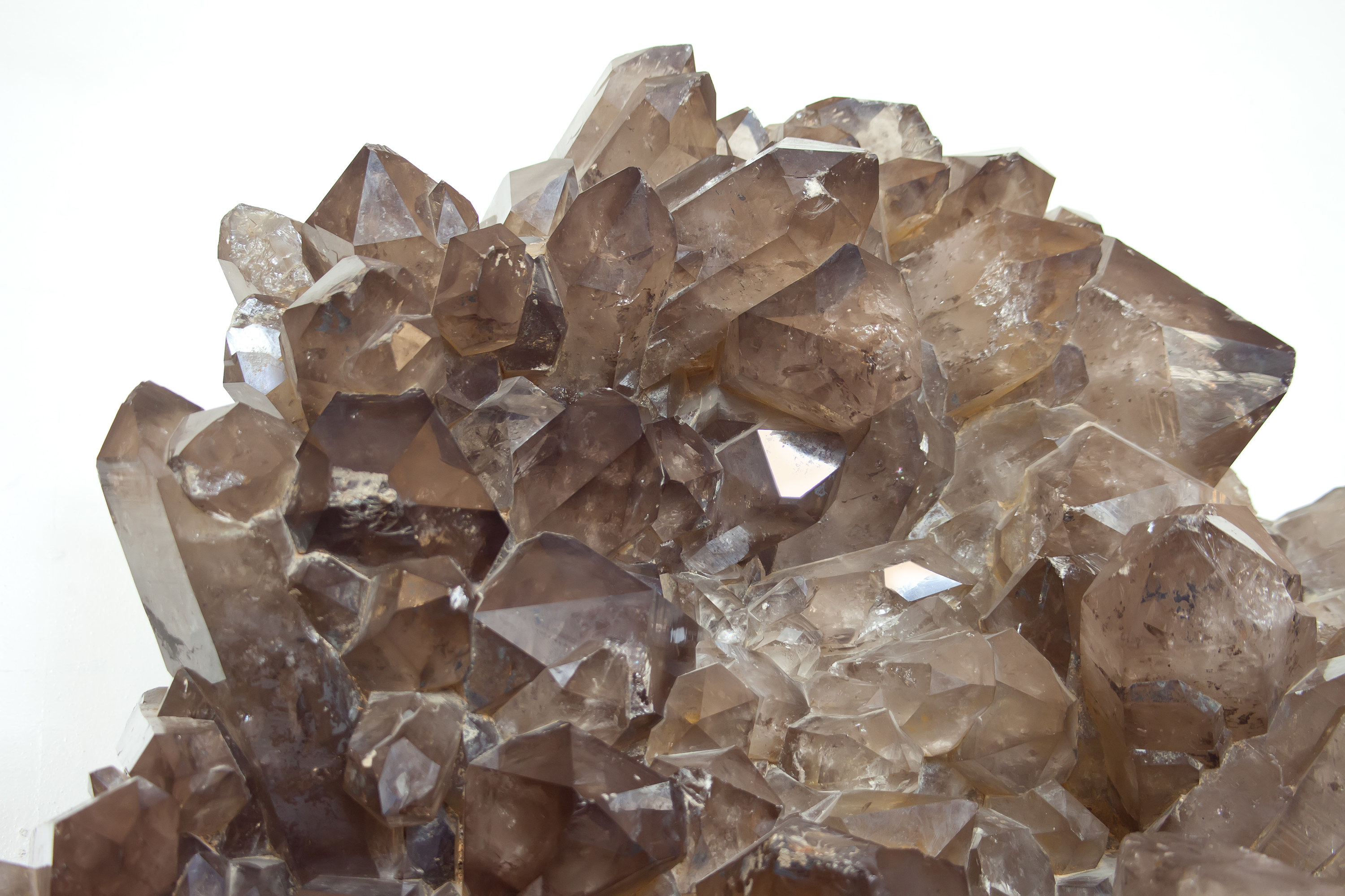 Cluster of smokey quartz crystals on white