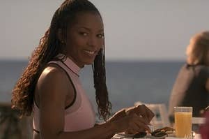 Actress Angela Bassett eats breakfast and smile at the camera. 