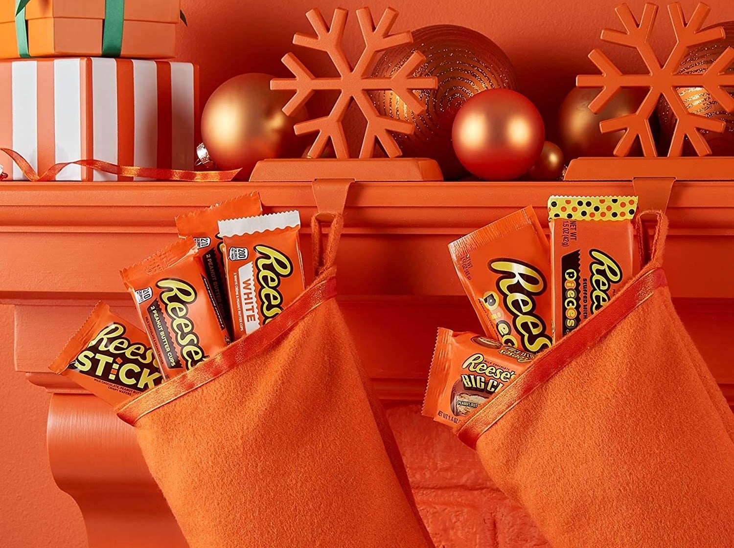 the contents of the variety pack inside orange stockings hanging on an orange mantel