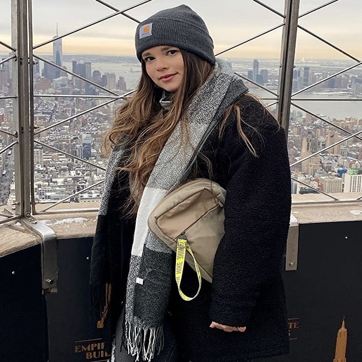 a reviewer wearing the plaid scarf in gray and white