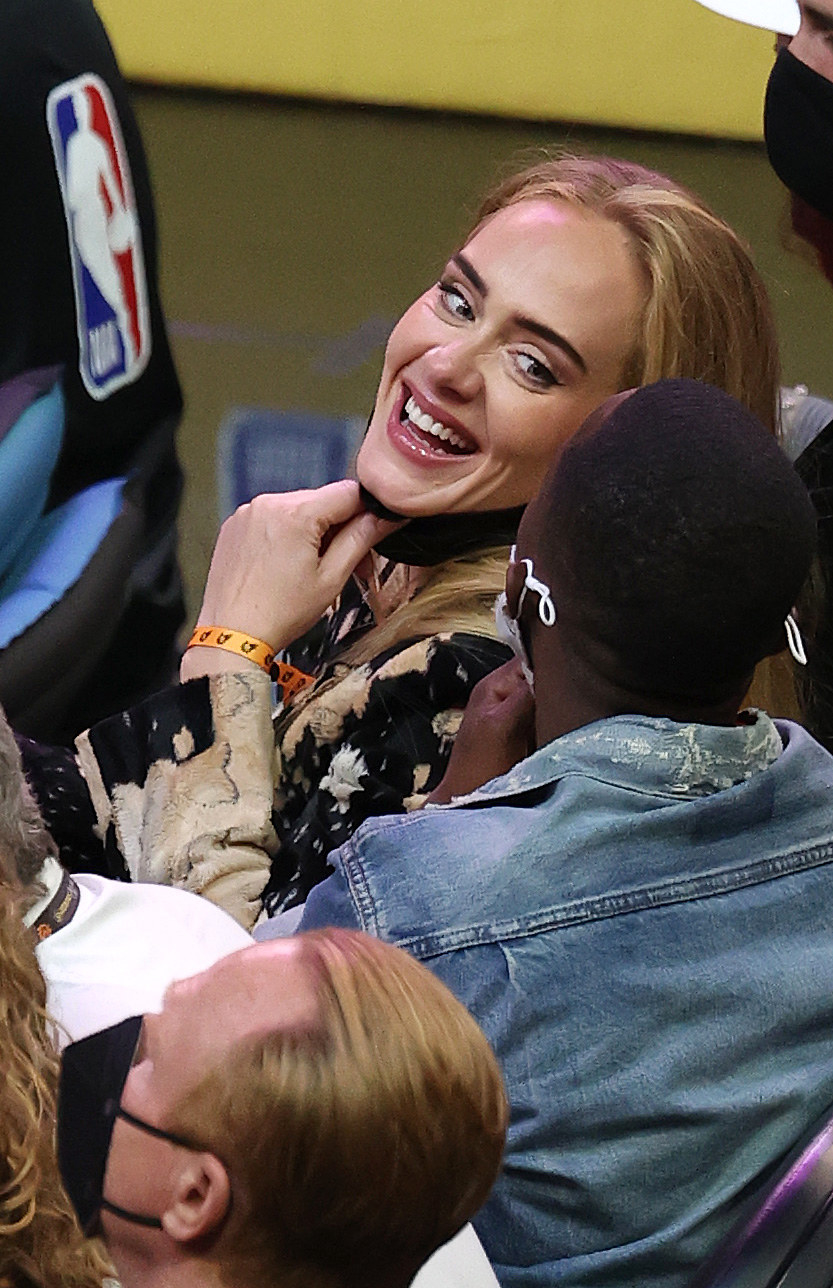 Adele smiles while looking over her shoulder at Rich Paul