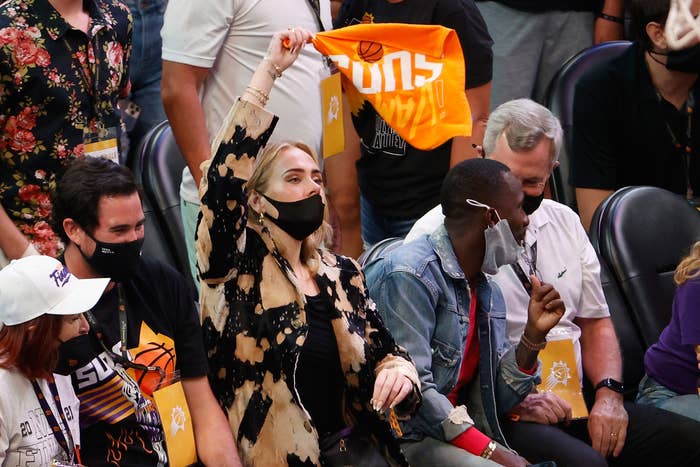 Adele waves a Phoenix Suns towel in the air