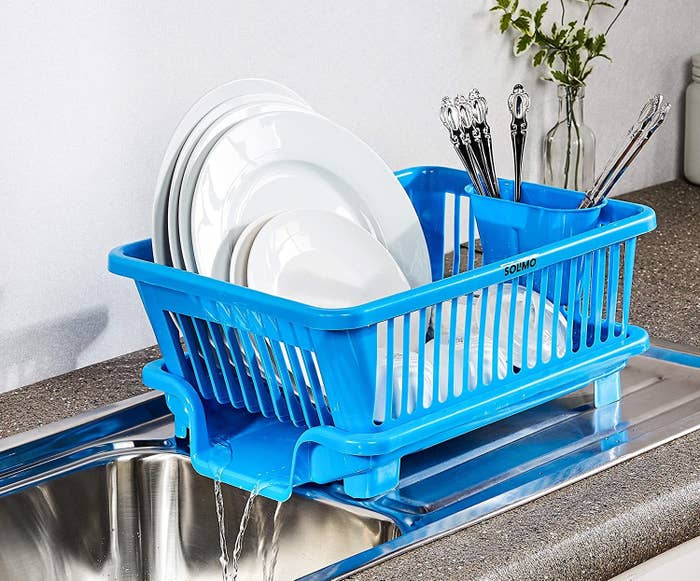 A dish drying rack with water running off the side