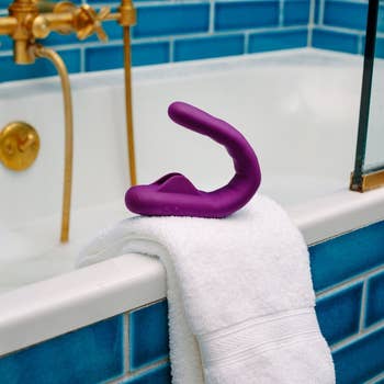 Purple vibrator on side of tub