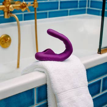 Purple vibrator on side of tub