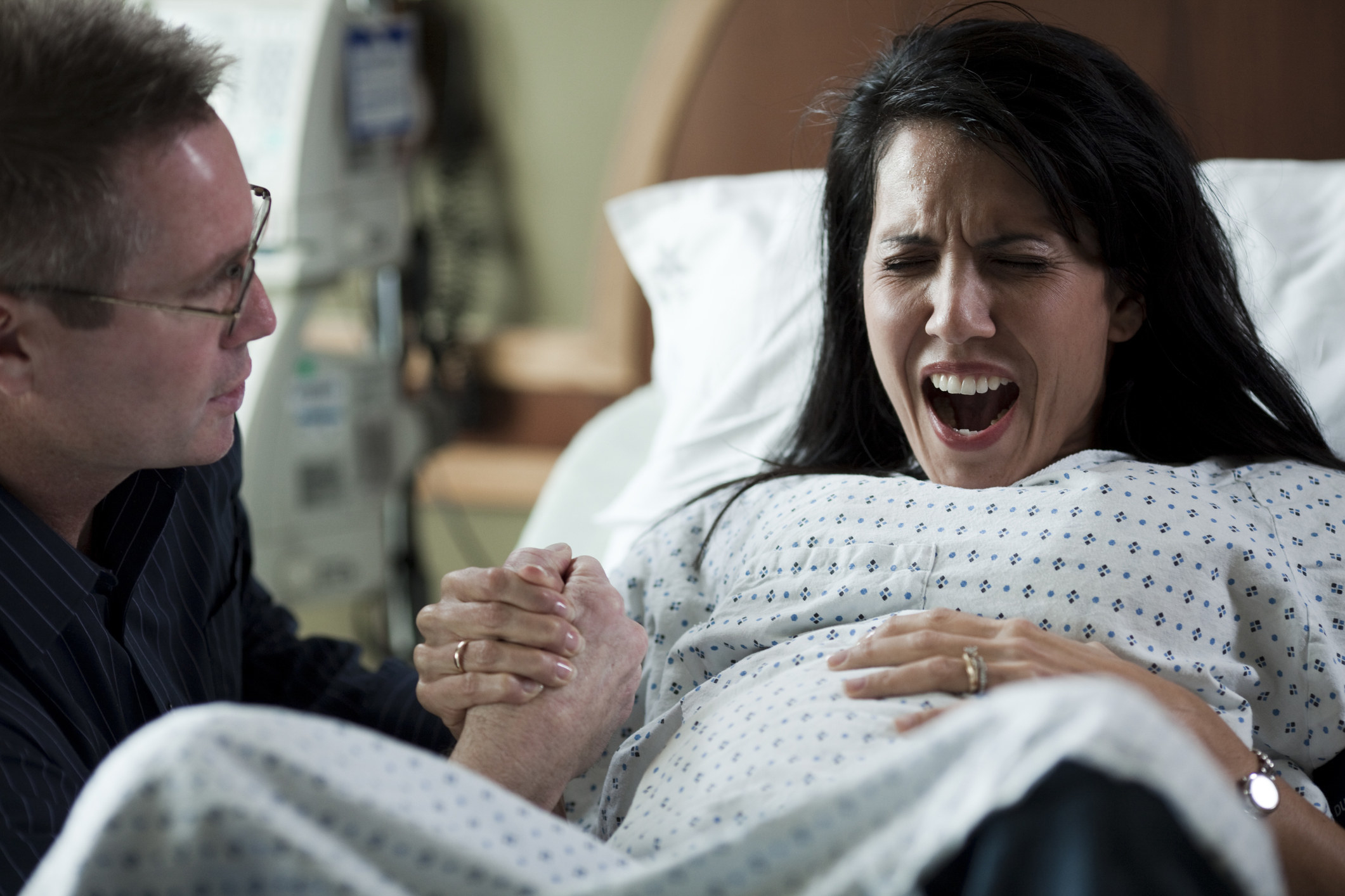 A woman screaming while in labor