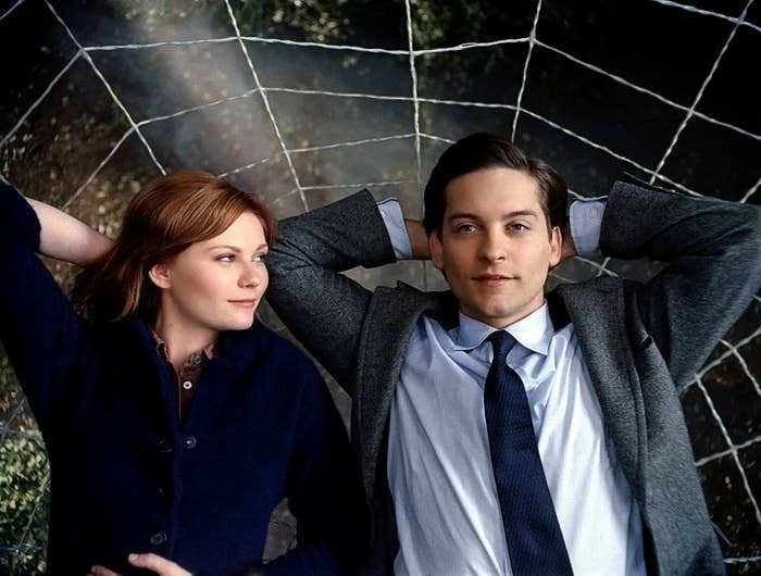 Kirsten Dunst lays next to Tobey Maguire on a spider web