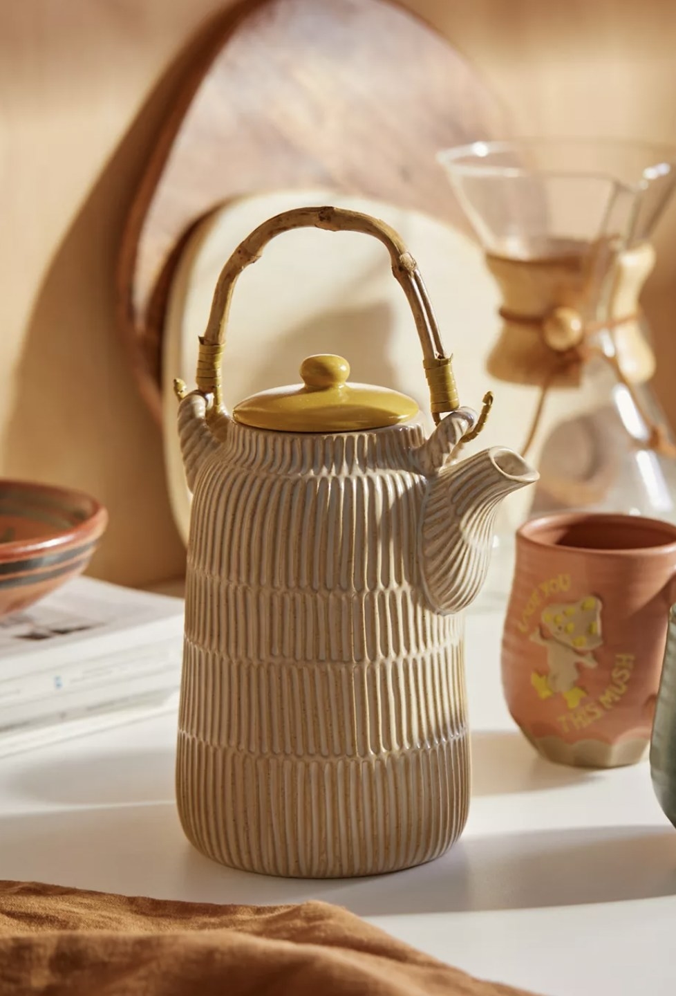 a coffee serving pot with a bamboo handle