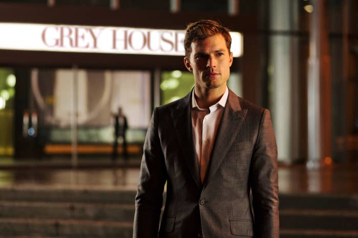Jamie Dornan looks in the distance with the words &quot;GREY HOUSE&quot; behind him