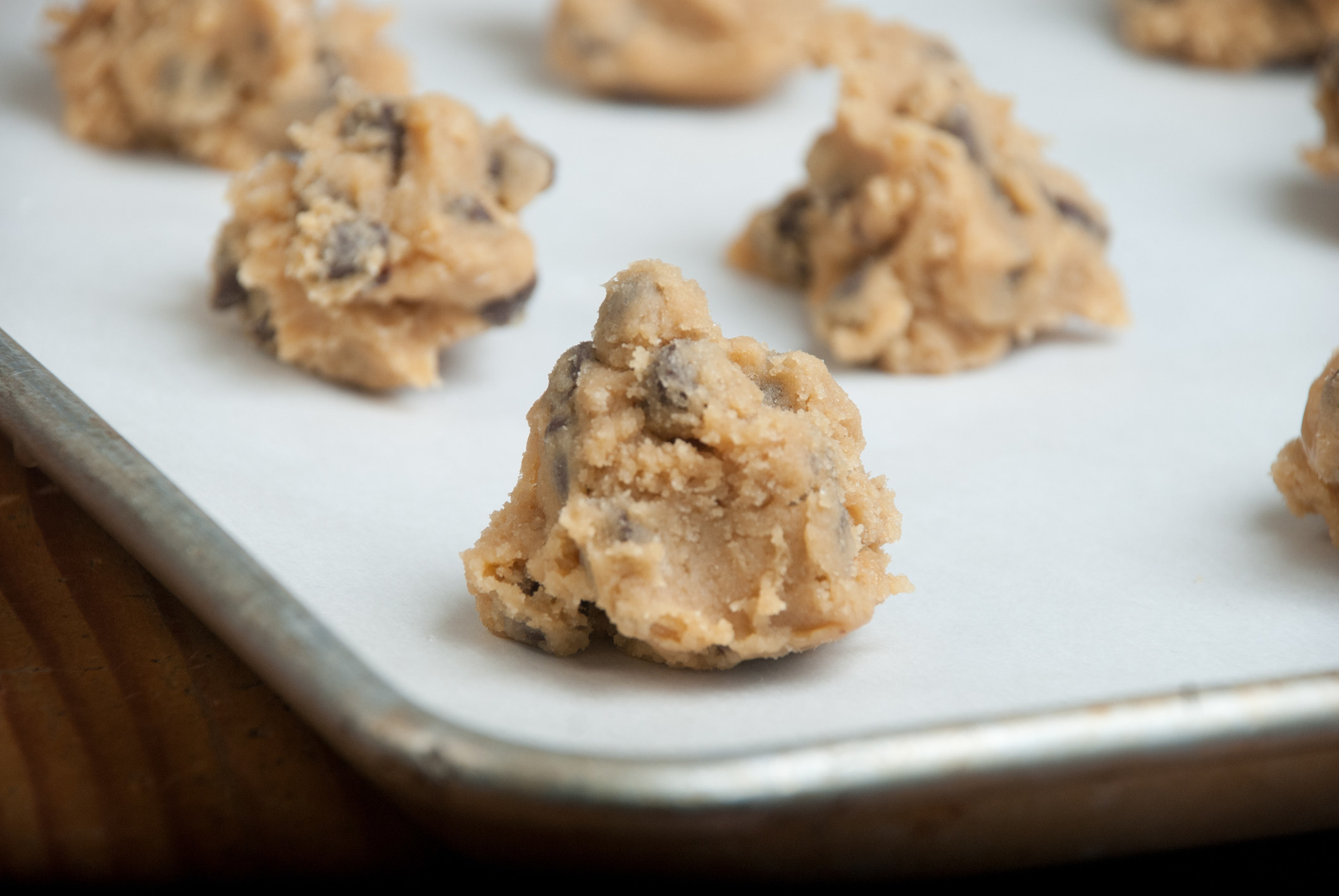 Spoonfuls of cookie dough on a baking sheet.