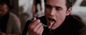 James Franco eating and smiling.
