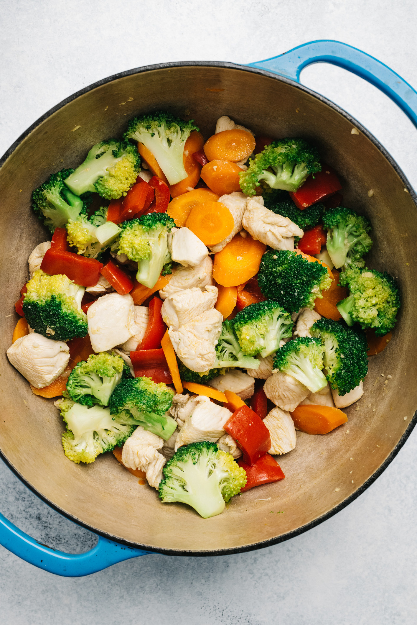 Vegetables and chicken in a Dutch oven.