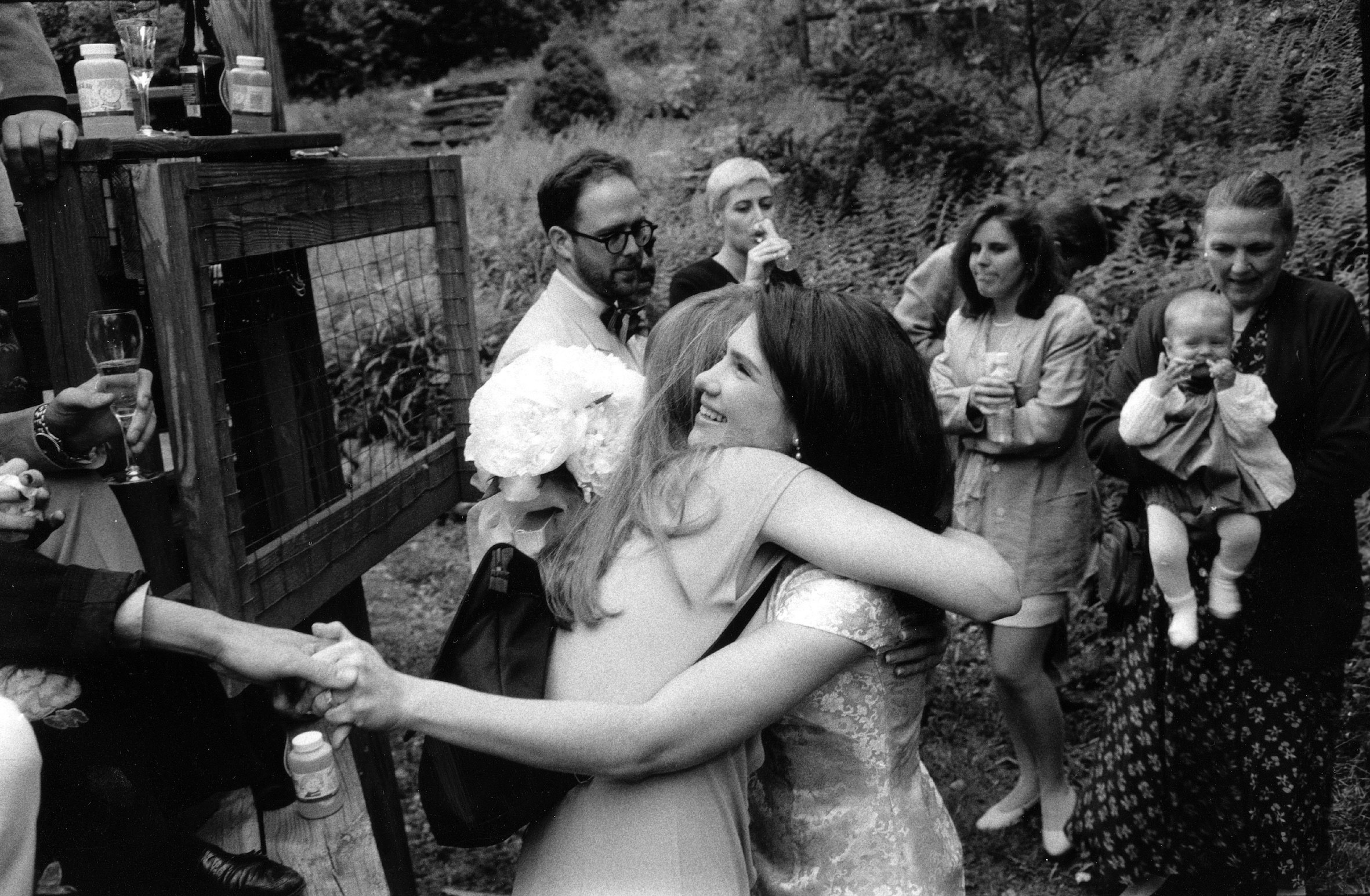 Blake receiving a hug and a handshake while surrounded by family