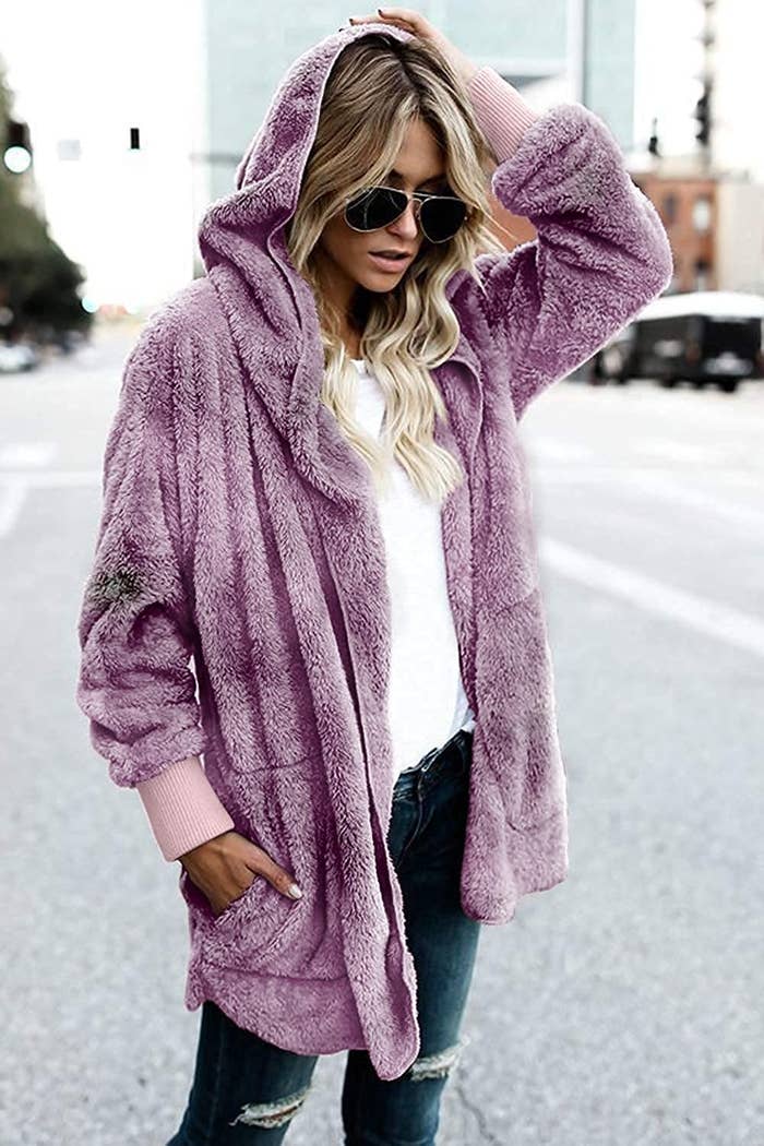 a person wearing the hooded fuzzy cardigan