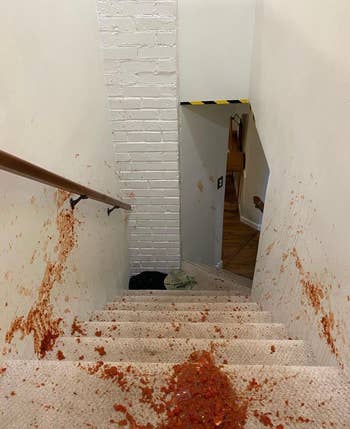 red salsa all over carpeted stairs