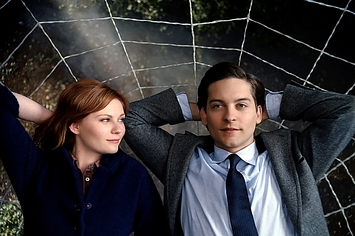Kirsten Dunst lays next to Tobey Maguire on a spider web