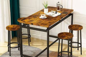 a wooden table with four bar stools