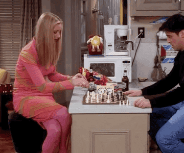 Phoebe from Friends playing chess with Joey
