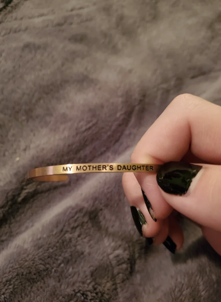 A bracelet that reads: &quot;My mother&#x27;s daughter&quot;