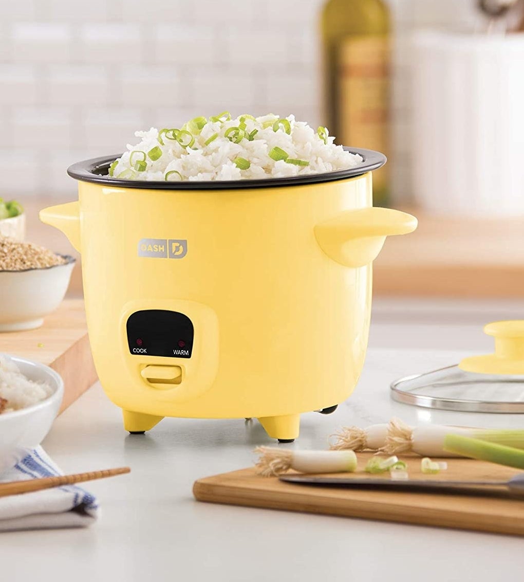 The yellow rice cooker filled with rice