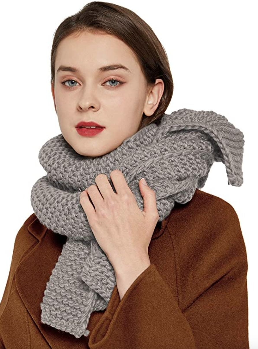Model wearing grey scarf with brown coat