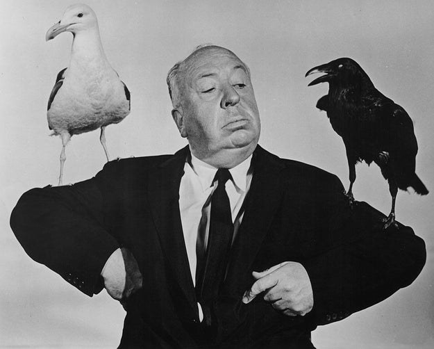 Hitchcock with birds on his arms