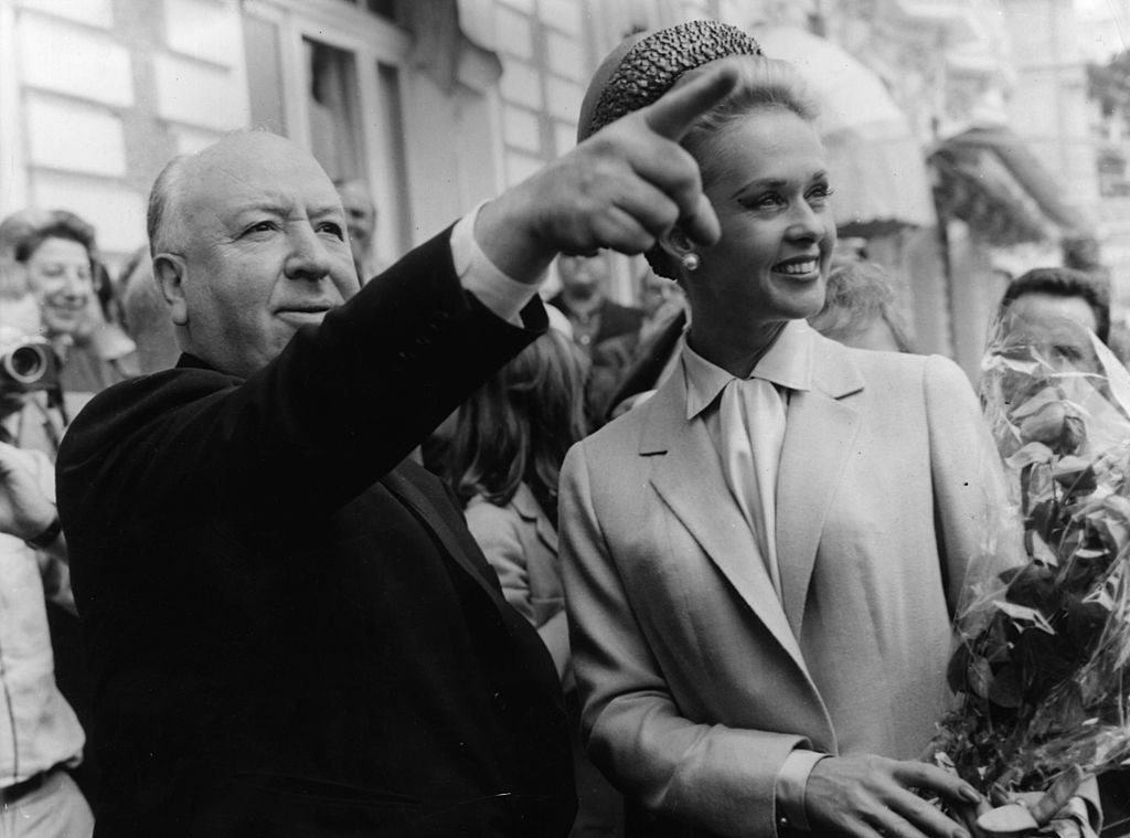 Hitchcock points something out to Hedren while they're in Cannes
