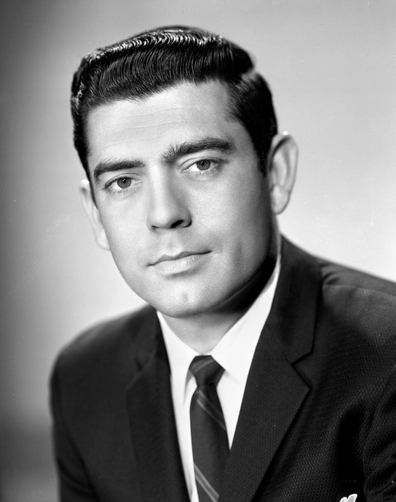 Dan Rather in 1962 in a suit and slicked-back hair