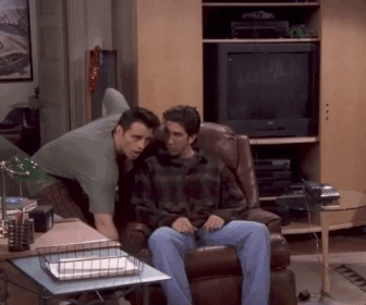 a gif of joey from friends showing ross how to recline in a chair