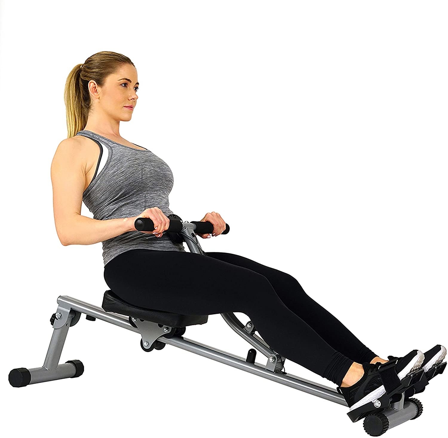 Woman on compact black and silver rowing machine