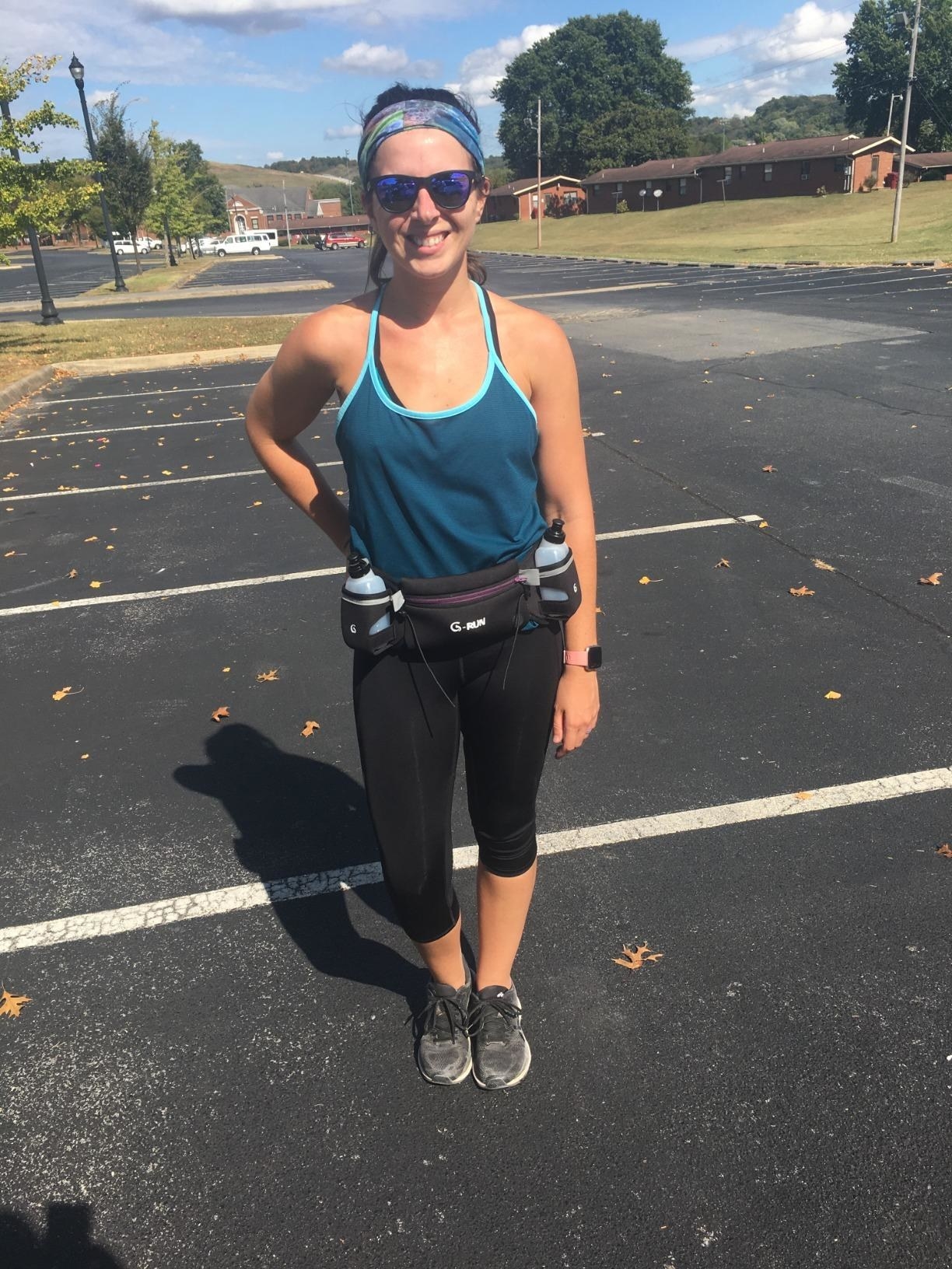 reviewer wears purple and black hydration running belt