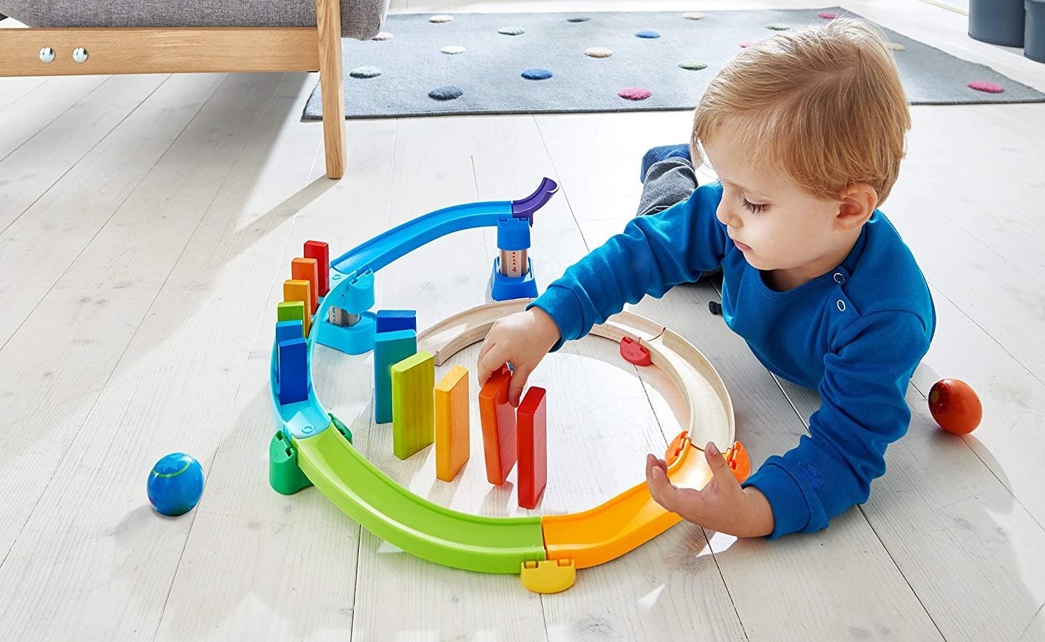 Child model playing with colorful domino playset