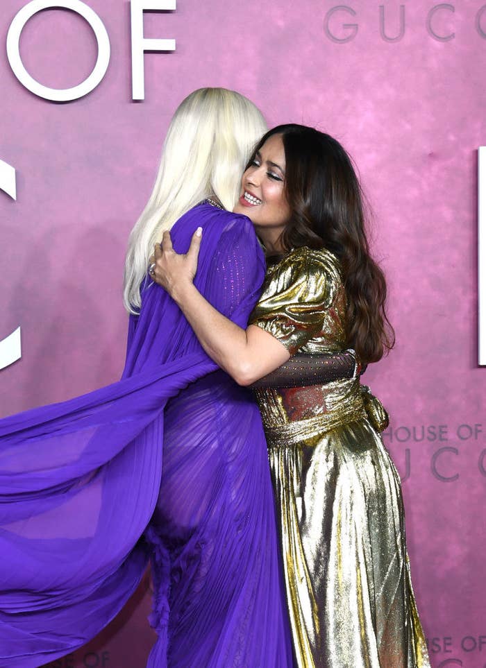 Lady Gaga and Salma Hayek hugging on the red carpet at the premiere of House of Gucci