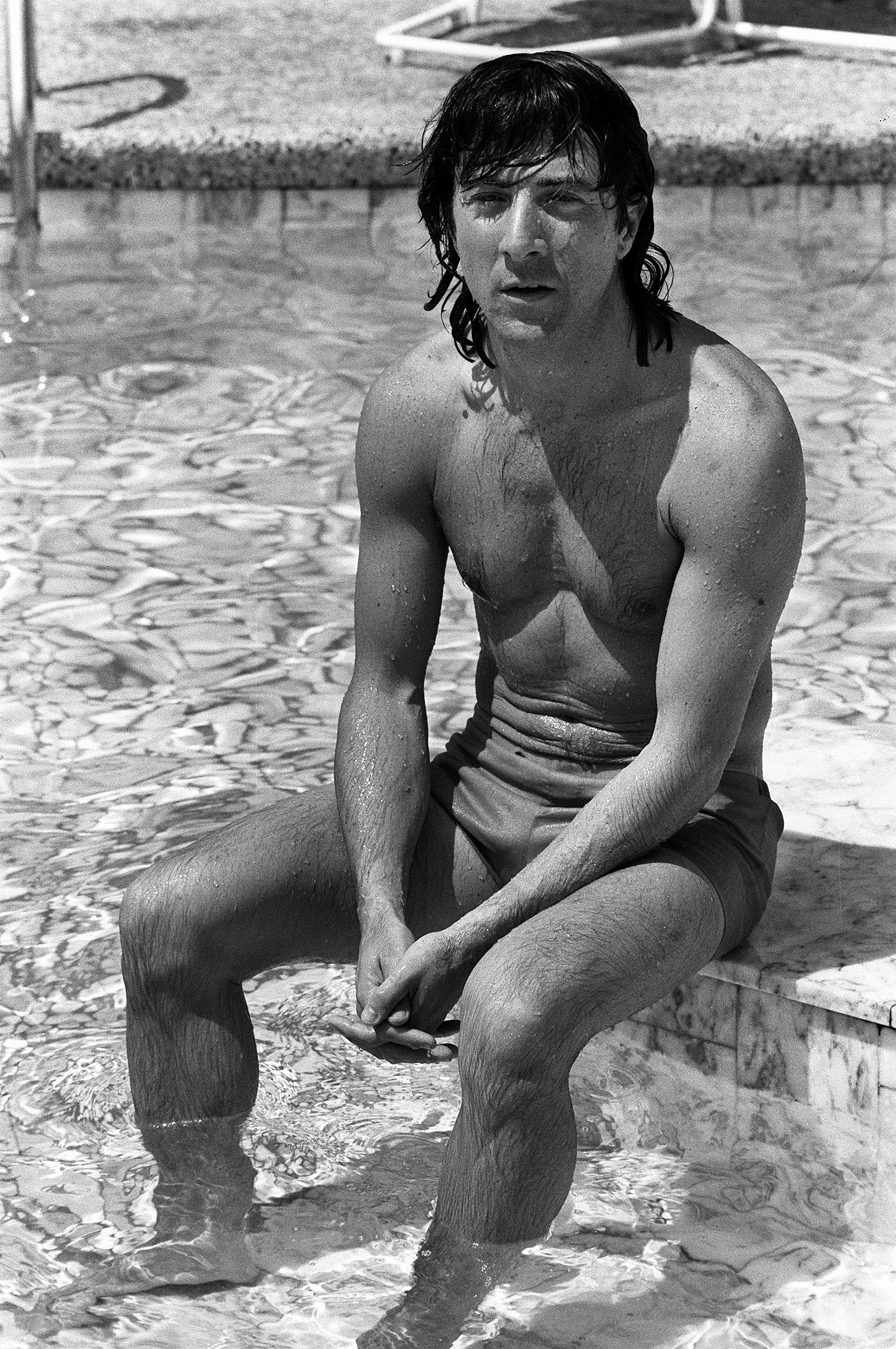 Dustin Hoffman poses in a pool in 1975