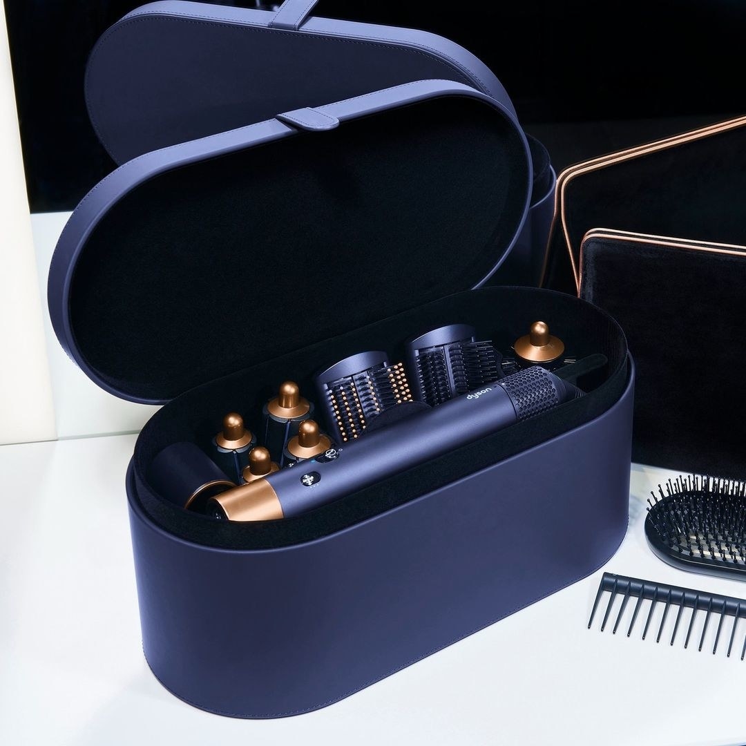 The hair tool in its box with all its different attachements