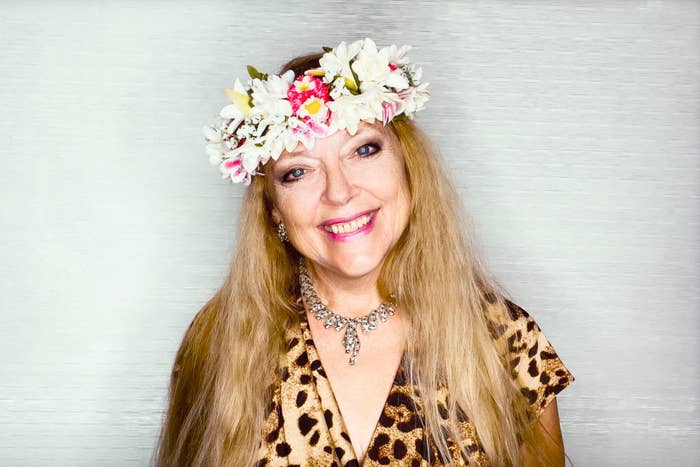 Carole Baskin smiling for her Dancing with the Stars portrait and wearing animal print clothing and a flower crown